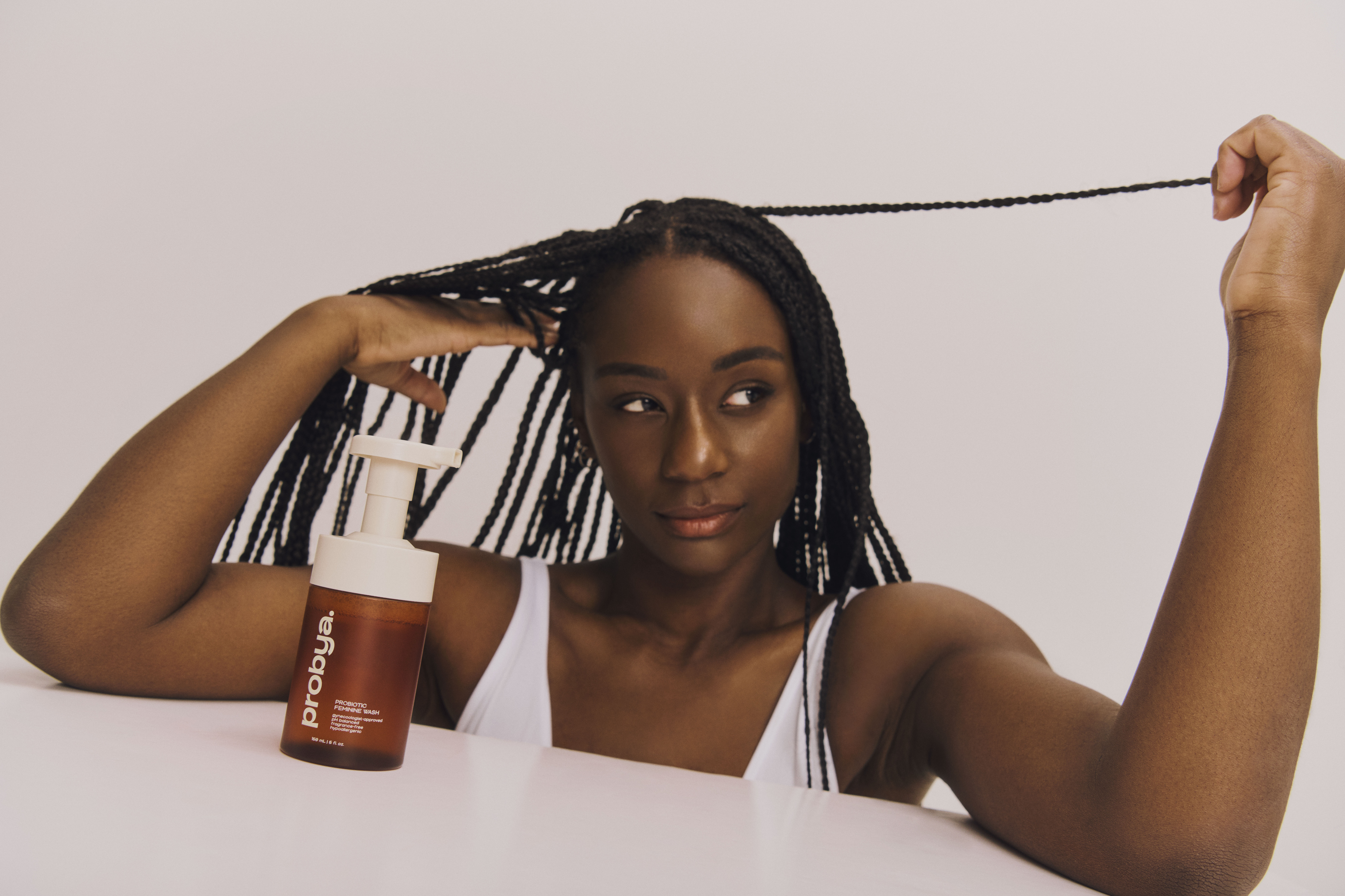 Woman in seated position with probya bottle in front